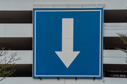sign huge white directional arrow on blue background