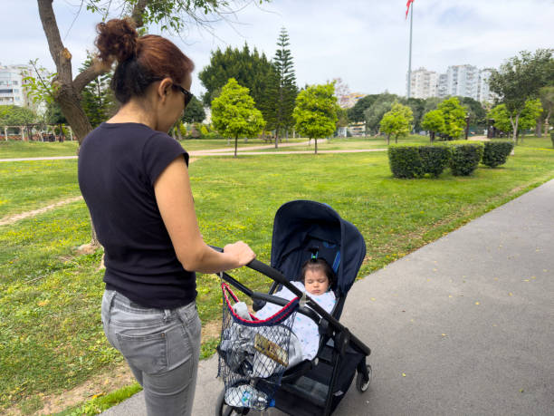 Young mother pushing baby stroller