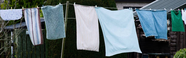 istock Washing line with towels drying in the garden 2148517252