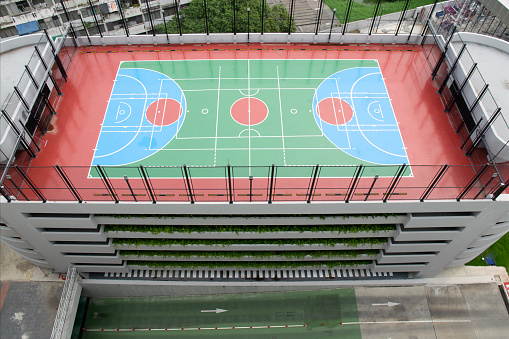 A basketball court with a blue and green court