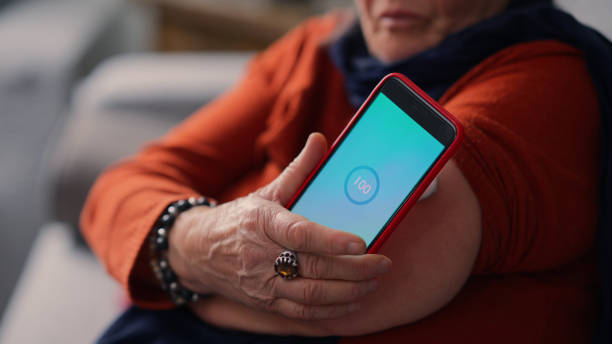 istock Senior woman using smart phone to check blood glucose level at home 2148517621