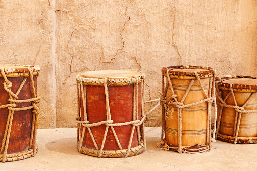 Vintage wooden drums over old wall background. Traditional mediterranean musical instrument