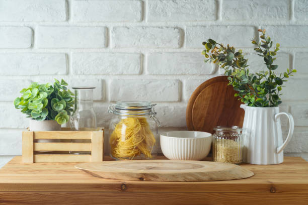 istock Empty wooden log  on kitchen table over white brick wall  background.  Kitchen mock up for design and product display. 2148517751