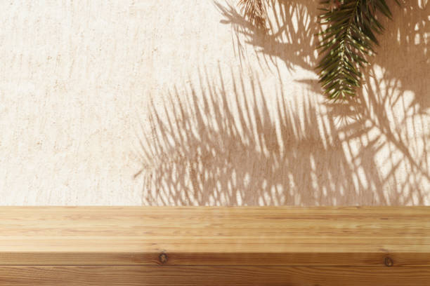 istock Empty wooden table over wall with palm tree shadow background. Summer picnic mock up for design and product display. 2148517752