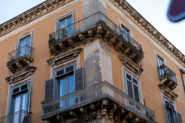 A building with a balcony has a lot of windows