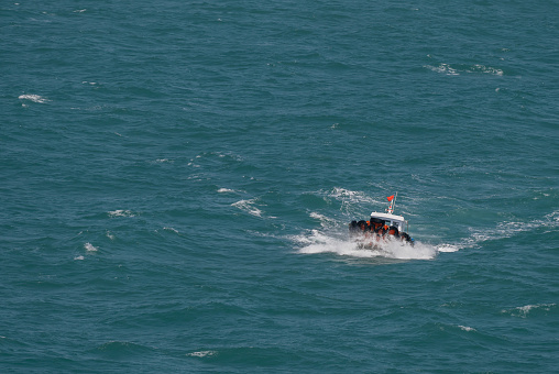 The Asian boat of the pilot in the high sea during a storm.