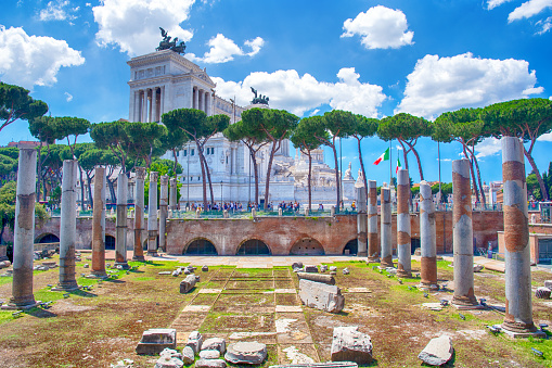Piazza Venezia is a central hub of Rome with Trajan's Forum on foreground, Italy