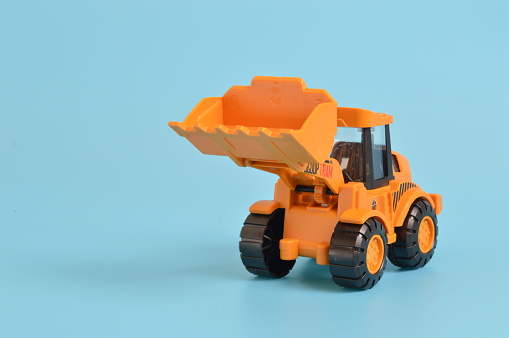 Industrial backhoe loader toy with excavator at a construction site