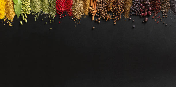 istock Spices and herbs on stone table, top view. Seasoning background on blackboard with empty space. 2148519317