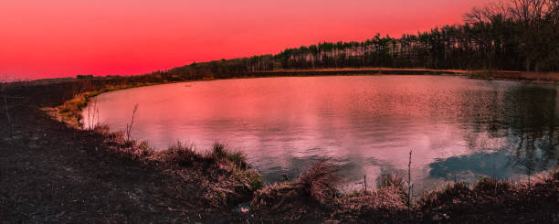 Sunset over prairie with pond and controlled burn areas in Madison, Wisconsin, USA