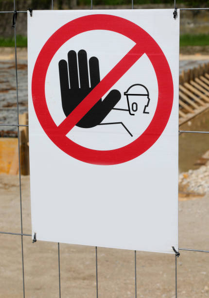 istock Warning signage prohibiting access with hand to construction site area 2148522157