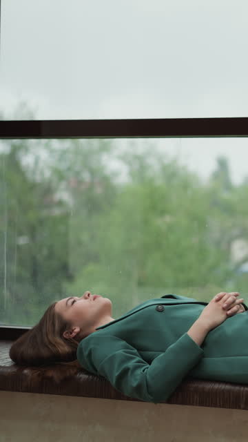 Weary lady executive collapsed on windowsill