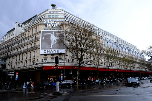 People walk outside of Galeries Lafayette in Paris, France  March 31, 2024.