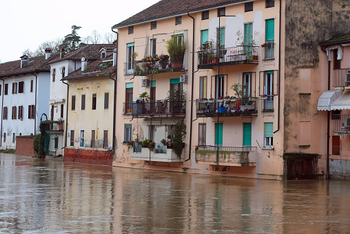 Floodwaters surge past houses threatening to overflow and cause disruption