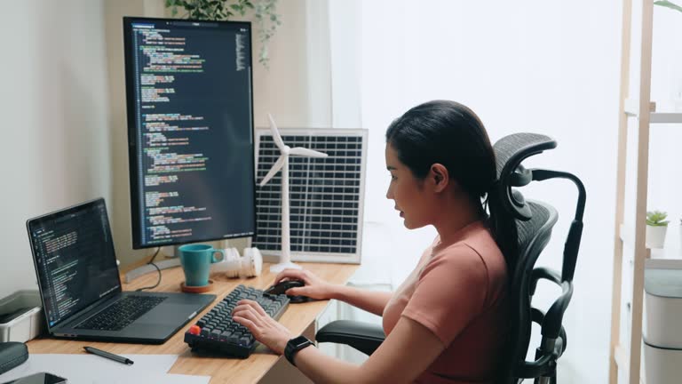 Asian woman Tech Professional in Thoughtful Coding at home