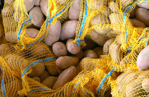 sacks of organic naturally potatoes without chemical fertilizers for sale at local market