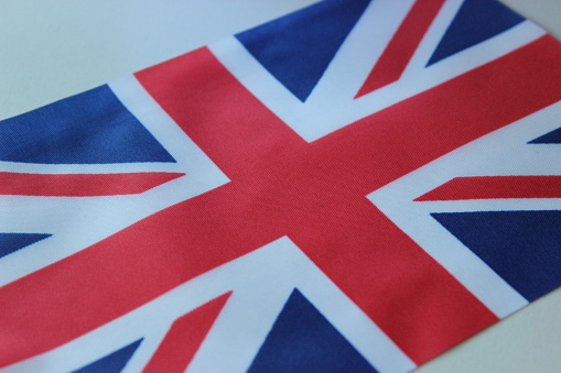 British flag. Macro photography of flag. The United Kingdom of Great Britain and Northern Ireland. Red, Blue, White