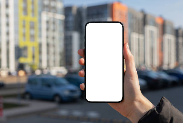 istock Holding mobile phone screen, blank smartphone display mockup, blurred city building 2148528241