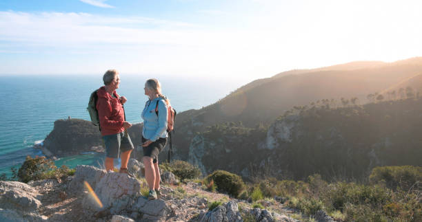 istock Mature couple hike along mountain ridge 2148529212