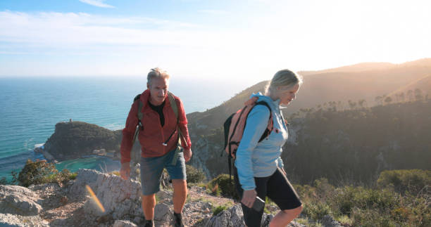 istock Mature couple hike along mountain ridge 2148529218
