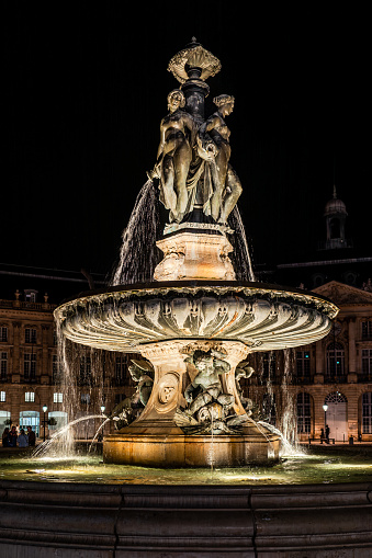 Bordeaux, France - April 6th, 2024: Bordeaux, Le Bourse quarter fountain at night with tourists
