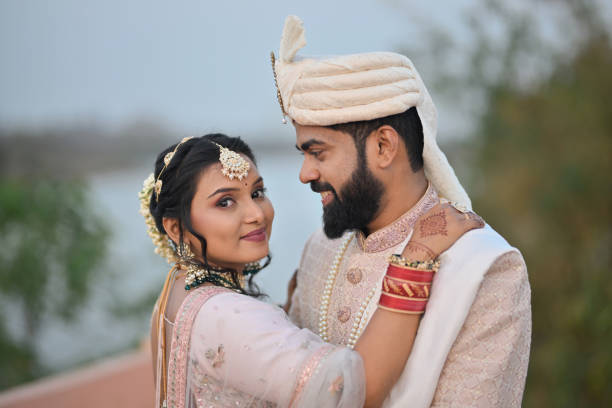 istock Bride and Groom wrapping the arms around each other while Bride looking at the camera 2148530704