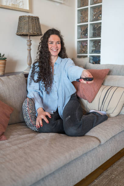istock Woman at home watching tv 2148531029
