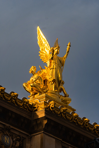 Paris, France - October 1, 2022: Golden coloured statues and decoration masterpieces of iconic French Opera Hall with great detail