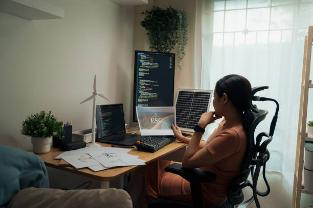 istock Asian woman professional examines materials at her tech-adept workspace 2148532362