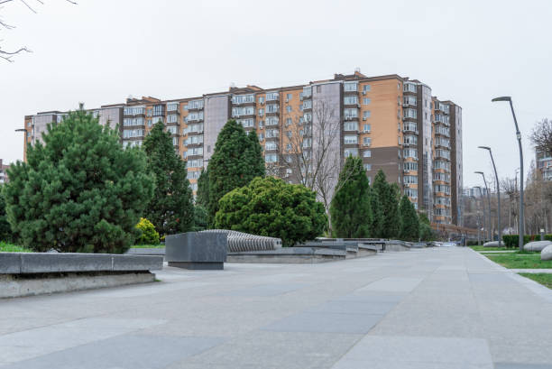 istock Nice modern leisure city park with benchs surrounded high-rise building. Public park. 2148533151