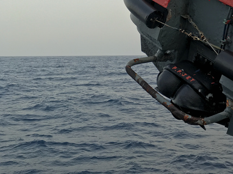 Jet powered engine boat lifted with the help of lifts and secured at sea