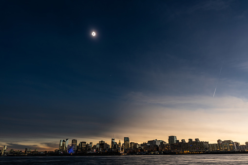 Total eclipse of the sun over the Montreal downtown on April 8th 2024. Series of three photos with 30 seconds between each one where you can see the moon shadow moving on the left side.