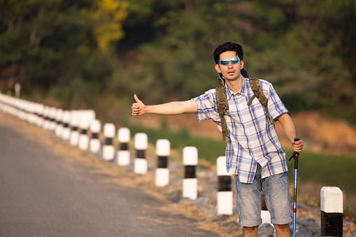 Traveller hitchhiking for the ride  during trip