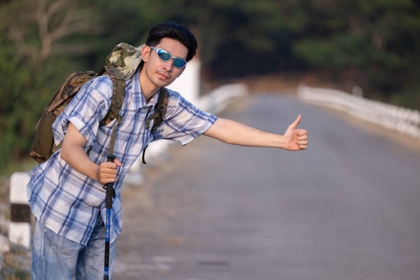 Traveller hitchhiking for the ride  during mountain trip