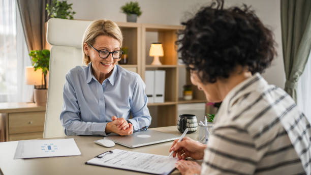 istock Two mature woman signature document, contract at work at office 2148534964
