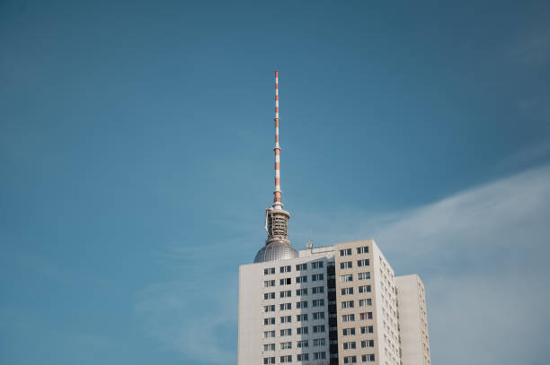 Berlin television tower partially hidden behind a high-rise building