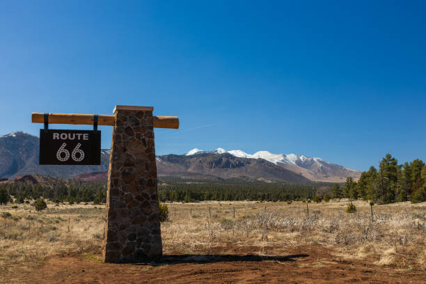 istock route 66 sign with snow capped mountains in background 2148536860