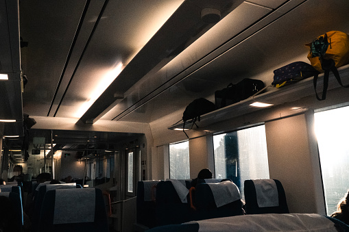 Interior of a commuter  train car at sunset.