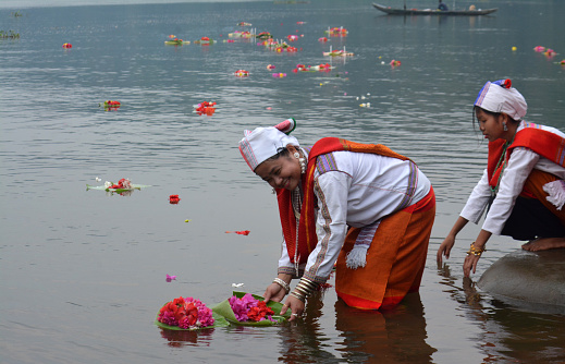Kaptai,Rangamati,Bangladesh12th April 2024 :The tribals of Bangladesh worship the Buddha with collected flowers and the flowers are floated in the water for the sake of Goddess Ganga in Kaptai,Rangamati,Bangladesh12th April 2024