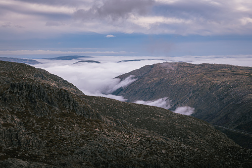 Majestic mountain ranges shrouded by clouds in Serra da Estrela Natural Park, in Portugal