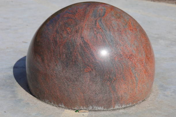 Granite brown ball on gray concrete
