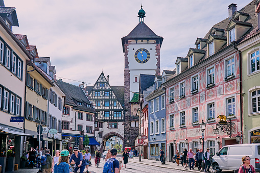 Freiburg, Germany - April 06, 2024: People walking in Kaiser-Joseph street in the direction of Martinstor in Freiburg im Breisgau, Germany