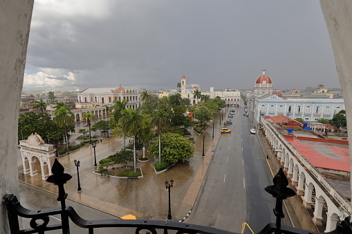 Cienfuegos, Cuba-October 11, 2019: Eastwards view from the turret on the SW corner of the Arts Museum along Calle San Fernando Street over Plaza Jose Marti Square to the Purisima Concepcion Cathedral.