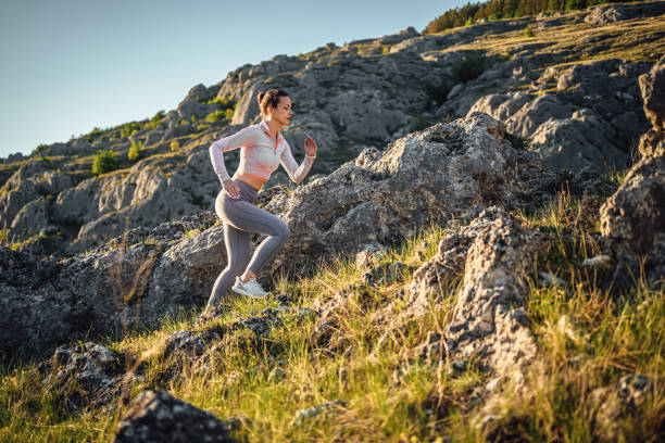 istock Sporty young woman running on a mountain 2148539945