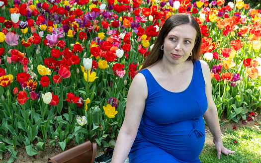 Beautiful pregnant  woman feeling lovely and smile in the park