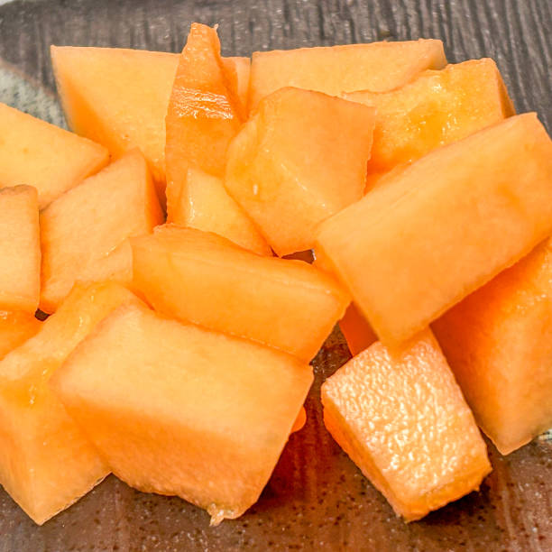 istock Chunks Of Cantaloupe On A Dark Background 2148540583