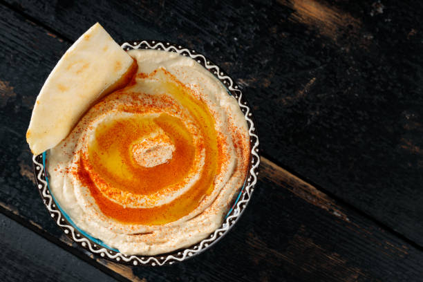 istock Hummus Bowl with Olive Oil and Pita on Dark Background, Copy Space 2148541012
