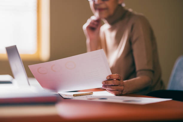 Senior Woman Reviewing Documents at Home