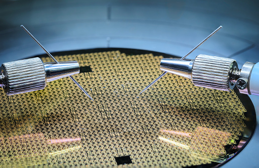Machine checking silicon wafers in clean room laboratory, close up. Silicon Wafers and Microcircuits with Automation system control application on automate robot arm
