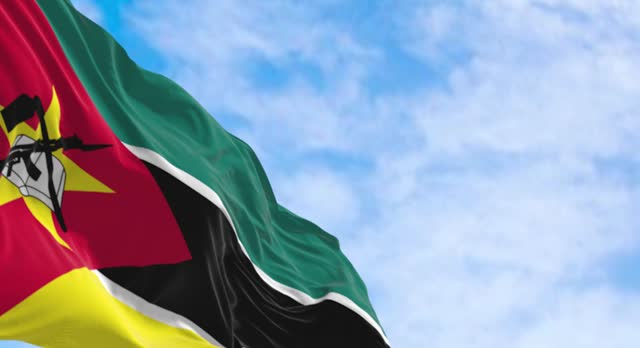 Close-up of Mozambique national flag waving on a clear day
